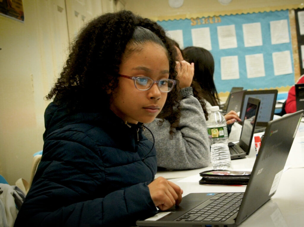 student at computer in class