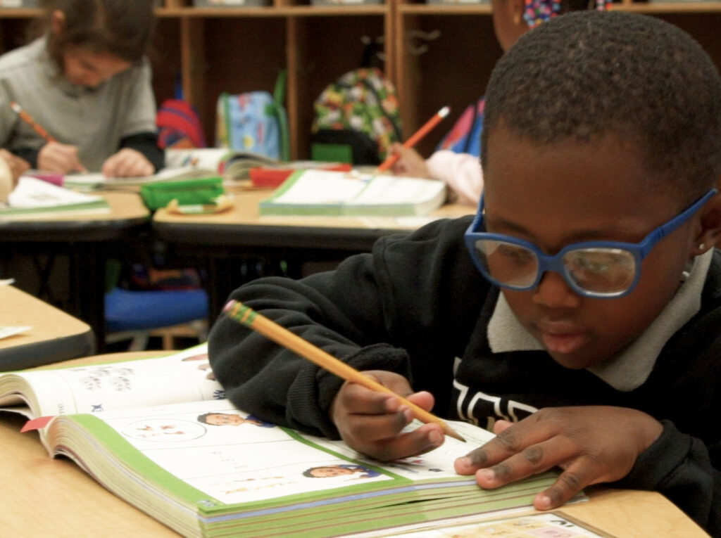 student working with book