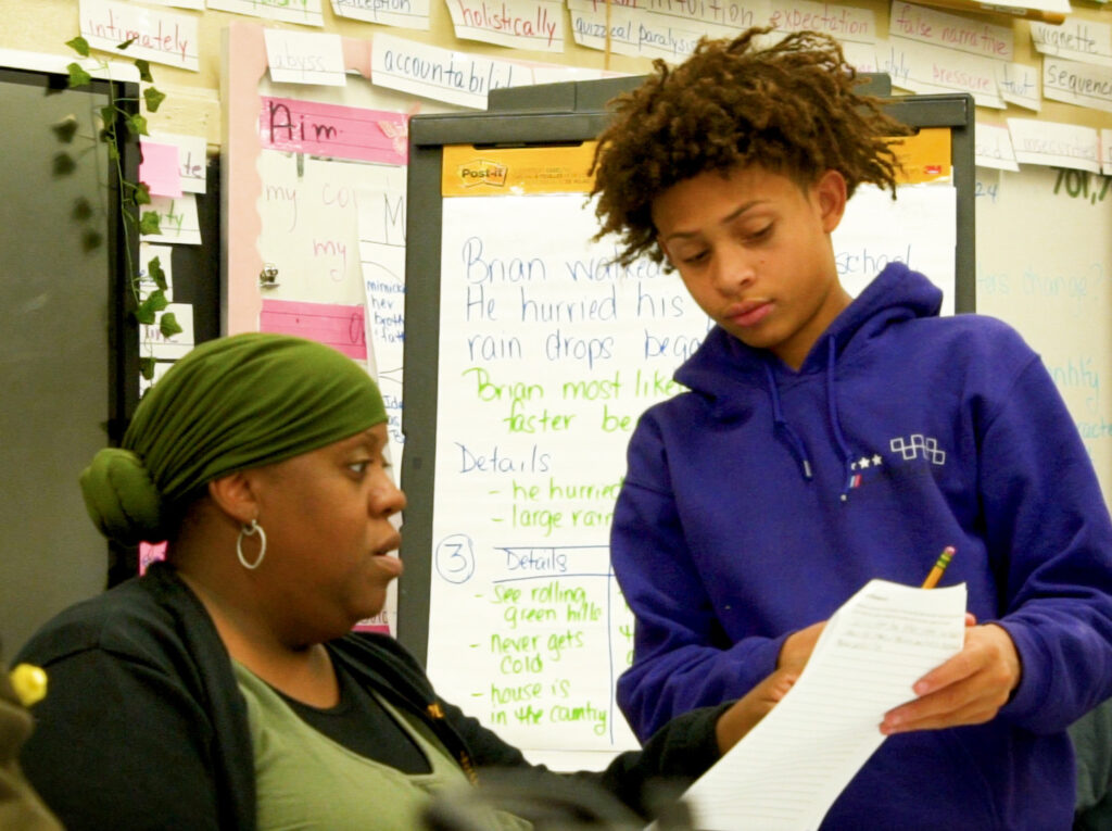 teacher working with student